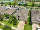 Aerial view of a home with well-manicured lawn and landscaping in a quiet neighborhood at 2450 Dovesong Trace Dr, Ruskin, FL 33570