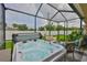 Covered back patio with a hot tub, perfect for outdoor enjoyment and relaxation at 2450 Dovesong Trace Dr, Ruskin, FL 33570