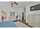 Bedroom featuring walk-in closet, hardwood floors, and white dresser at 2450 Dovesong Trace Dr, Ruskin, FL 33570