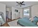 Bright bedroom features an interior mirror, window with blinds, ceiling fan, and closet at 2450 Dovesong Trace Dr, Ruskin, FL 33570