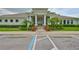 Well-maintained clubhouse entrance with manicured landscaping, parking and beautiful architecture at 2450 Dovesong Trace Dr, Ruskin, FL 33570