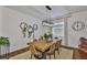 Stylish dining area featuring a rustic table, modern lighting, and charming decor at 2450 Dovesong Trace Dr, Ruskin, FL 33570