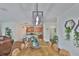 Dining area featuring a rustic wood table and modern lighting fixture at 2450 Dovesong Trace Dr, Ruskin, FL 33570