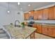 Kitchen island with granite countertops, stainless steel appliances, and custom cabinetry at 2450 Dovesong Trace Dr, Ruskin, FL 33570