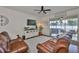 Cozy living room featuring hardwood floors, leather seating, and access to an outdoor patio at 2450 Dovesong Trace Dr, Ruskin, FL 33570