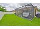 The screened in patio features comfortable seating, hot tub, with a beautiful lawn at 2450 Dovesong Trace Dr, Ruskin, FL 33570