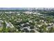 Stunning aerial view of a neighborhood with lush trees and distant city skyline providing a unique perspective on the property's location at 2596 Floyd St, Sarasota, FL 34239