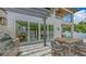 Outdoor kitchen, seating area, and sliding glass doors offer a seamless transition to indoor/outdoor living at 2596 Floyd St, Sarasota, FL 34239