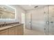 Bathroom vanity is framed by LED mirror and glass shower with marble-look tile at 2596 Floyd St, Sarasota, FL 34239