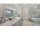 Modern bathroom with marble shower, standalone tub, double vanity, and sleek design elements at 2596 Floyd St, Sarasota, FL 34239