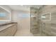 Sleek bathroom showcasing a glass shower with stylish tile and a vanity with an illuminated mirror at 2596 Floyd St, Sarasota, FL 34239