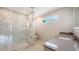 Bathroom featuring a glass shower with designer tile, a single sink and a window at 2596 Floyd St, Sarasota, FL 34239