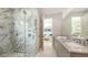 Elegant bathroom featuring a marble shower and double sink vanity with modern fixtures at 2596 Floyd St, Sarasota, FL 34239