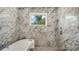 Luxurious bathroom with a standalone tub, rainfall shower head, and marble accents at 2596 Floyd St, Sarasota, FL 34239