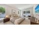Comfortable bedroom with large window and sliding door to patio space with seating at 2596 Floyd St, Sarasota, FL 34239