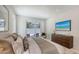 Tastefully decorated bedroom with TV, luxurious bed, and view of the outside patio at 2596 Floyd St, Sarasota, FL 34239
