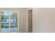A bright and modern bedroom provides a calming view from the sliding glass doors to a private outdoor patio at 2596 Floyd St, Sarasota, FL 34239