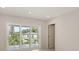 Bright bedroom featuring recessed lighting, and sliding door access to an outdoor patio with treetop views at 2596 Floyd St, Sarasota, FL 34239