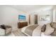 Well-appointed bedroom with TV, neutral decor, and an en-suite bathroom for convenience at 2596 Floyd St, Sarasota, FL 34239