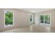 Bright bedroom featuring tile floors, recessed lighting, and windows with lush outdoor views and sliding door access at 2596 Floyd St, Sarasota, FL 34239