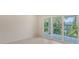 Bright bedroom featuring tile floors, recessed lighting, and sliding door access to an outdoor patio space at 2596 Floyd St, Sarasota, FL 34239