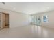 Bright and airy bedroom featuring tile flooring, French doors, and a closet for ample storage at 2596 Floyd St, Sarasota, FL 34239
