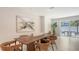 Bright dining room featuring a modern table with seating for six and backyard views at 2596 Floyd St, Sarasota, FL 34239
