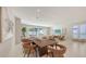Bright, open-plan dining room with modern furniture and a view to the outdoor living area at 2596 Floyd St, Sarasota, FL 34239