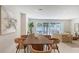 Bright dining room featuring a modern table with seating for six and backyard views at 2596 Floyd St, Sarasota, FL 34239