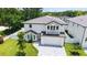 Aerial view of the house featuring a balcony, lush greenery and a well-manicured lawn at 2596 Floyd St, Sarasota, FL 34239