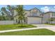Charming two-story home featuring a second story balcony, attached garage and well-manicured lawn at 2596 Floyd St, Sarasota, FL 34239