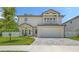 Charming two-story home featuring a second story balcony, attached garage and well-manicured lawn at 2596 Floyd St, Sarasota, FL 34239