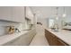 Bright, modern kitchen with waterfall countertops, high-end appliances, and sleek cabinets at 2596 Floyd St, Sarasota, FL 34239