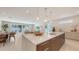 Spacious open concept features island, dining area, and living room with sliding doors and ample light at 2596 Floyd St, Sarasota, FL 34239