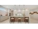 Gourmet kitchen with an island, breakfast bar, modern cabinets, and stainless steel appliances at 2596 Floyd St, Sarasota, FL 34239