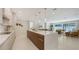 Modern kitchen featuring a large center island with a waterfall countertop and an open floor plan at 2596 Floyd St, Sarasota, FL 34239
