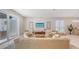 Bright living room boasts a comfortable beige sofa, stylish chairs, and a sliding glass door to an outdoor entertainment area at 2596 Floyd St, Sarasota, FL 34239