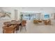 Open-concept living and dining area with modern furnishings and sliding glass doors for seamless indoor-outdoor living at 2596 Floyd St, Sarasota, FL 34239