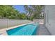 Sparkling in-ground pool with privacy fence and gray brick trim at 2596 Floyd St, Sarasota, FL 34239