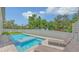 Relaxing backyard with a refreshing pool, lounge chairs, and manicured landscaping at 2596 Floyd St, Sarasota, FL 34239