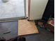 Damaged doorway with wood paneling on the floor at 3006 Hawthorne St, Sarasota, FL 34239