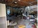 Spacious garage area cluttered with furniture and items scattered on the floor at 3006 Hawthorne St, Sarasota, FL 34239