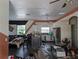 Open-concept kitchen with white cabinets and dark tile flooring in need of renovation at 3006 Hawthorne St, Sarasota, FL 34239