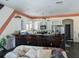Kitchen with a bar, white cabinets, dark countertops, and ceiling fan at 3006 Hawthorne St, Sarasota, FL 34239