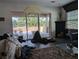 Living room showcasing a sliding glass door that leads to a patio; property in need of renovation at 3006 Hawthorne St, Sarasota, FL 34239