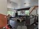 Living room and kitchen combo with dark floors and lots of natural light; property in need of renovation at 3006 Hawthorne St, Sarasota, FL 34239