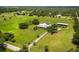 Beautiful aerial view of the farmhouse, barn, pond, pastures, and surrounding green landscape at 3100 Lena Ln, Sarasota, FL 34240