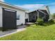 This home features a screened porch, outdoor shower, and a well-manicured lawn at 3100 Lena Ln, Sarasota, FL 34240