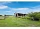 This rural property features a large barn surrounded by lush green pasture land at 3100 Lena Ln, Sarasota, FL 34240