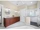 Well-lit bathroom boasting a double vanity, glass shower, and classic penny tile at 3100 Lena Ln, Sarasota, FL 34240